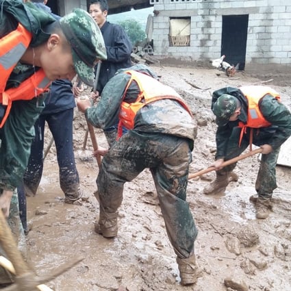 Rescue workers dig at the disaster site after a landslide hit the village of Gengdi in Qiaowo town on Tuesday. Photo: Xinhua