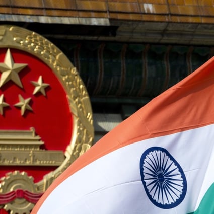 The Indian national flag flies next to the Chinese national emblem outside the Great Hall of the People in Beijing. The two nations could be on the brink of war. Photo: AP
