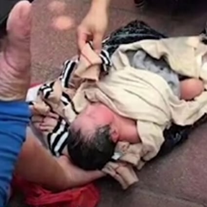 The baby girl lying on the street after the courier found her wrapped in bags. Photo: Handout