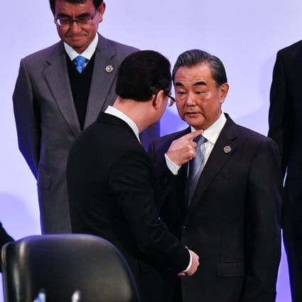 Chinese Foreign Minister Wang Yi talks with the Philippine Foreign Secretary Alan Peter Cayetano at the Asean meeting in Manila. Photo: EPA