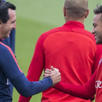 Paris Saint-Germain coach Unai Emery (left) greets Neymar during a training session at the Camp des Loges training centre in Paris. Photo: AP