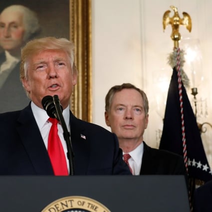 US President Donald Trump, flanked by Treasury Secretary Steven Mnuchin, left, US Trade Representative Robert Lighthizer, second from right, and Commerce Secretary Wilbur Ross, right, speaks before signing a memorandum directing the US Trade Representative to complete a review of trade issues with China. Photo: Reuters