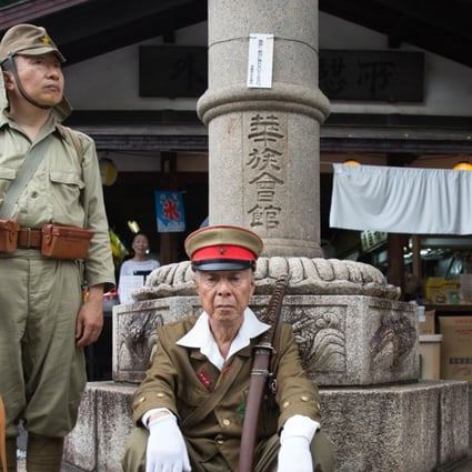 Japanese men wear imperial army uniforms at the Yasukuni Shrine in Tokyo. Photo: AFP