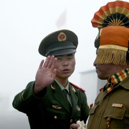 A Chinese soldier (L) gestures next to an Indian soldier at the Nathu La border crossing between India and China in India's northeastern Sikkim state. An altercation has broken out between Chinese and Indian troops. Photo: AFP