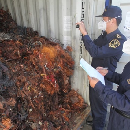 A file picture of customs officers checking imported foreign waste metal at a port in Qingdao in Shandong province. Photo: China Foto Press