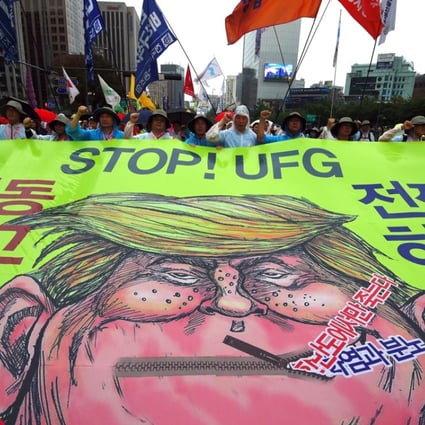 South Korean protesters carry a caricature of US President Donald Trump towards the US embassy in Seoul. Photo: AFP