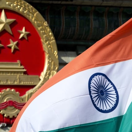 A Chinese emblem and an Indian flag at the Great Hall of the People in Beijing. Photo: AP