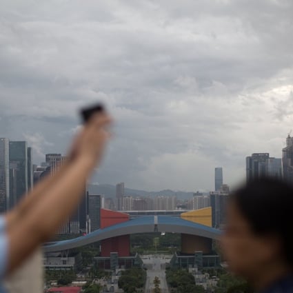 The Greater Bay Area encompasses 11 cities covering a 56,500 square kilometre. A couple take selfies overlooking Shenzhen’s business district. Photo: EPA