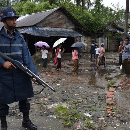 An armed policeman on guard at a displacement camp for the minority Muslim Rohingya in Myanmar’s Rakhine State. Picture: AFP