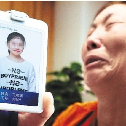 The woman’s family member with a photo of the woman who died after she fell off a building in Hangzhou, Zhejiang province. Photo: Handout