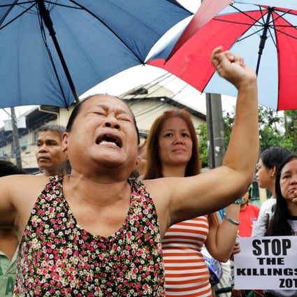 A woman, whose son was also shot in a drug-related killing, cries during the funeral march of Kian Loyd Delos Santos. Photo: Reuters