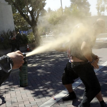 Joey Gibson, the leader of the Patriot Prayer group (right), is blasted with pepper spray in Berkeley, California, on Sunday. Photo: AP
