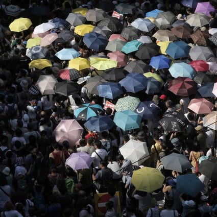 Protesters use umbrellas as shelter from the sun at a demonstration against the jailing of pro-democracy activists. Photo: AP