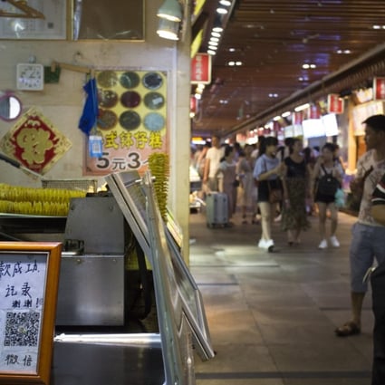 A stall in Shenzhen’s Dong Men Ding Plaza displays a QR code for mobile payment. Photo: May Tse