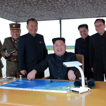 North Korean leader Kim Jong-un smiles as he watches the test launch of a Hwasong-12 intermediate-range missile. Photo: AP