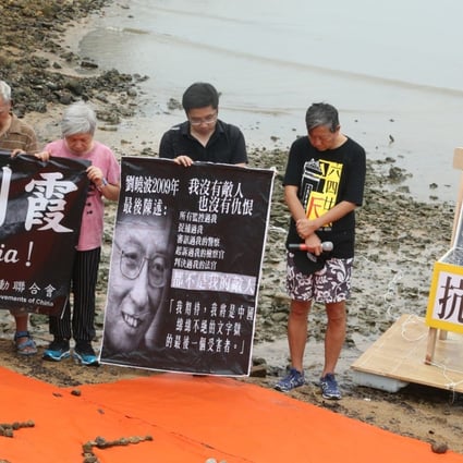 Members of the Hong Kong Alliance in Support of Patriotic Democratic Movements of China hold a memorial service by the sea in Sai Kung to commemorate Noble Laureate Liu Xiaobo. Photo: David Wong