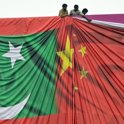 Workers arrange a banner featuring the Chinese and Pakistani flags ahead of a visit to Islamabad by China’s President Xi Jinping in 2015. Pakistan’s Foreign Minister Khawaja Asif is expected to arrive in Beijing on Friday. Photo: AFP