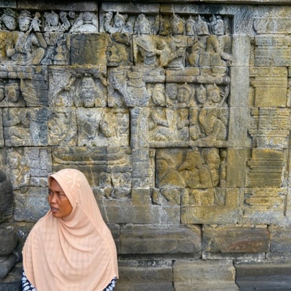 A woman visits the Buddhist temple of Borobudur. Photo: Alamy