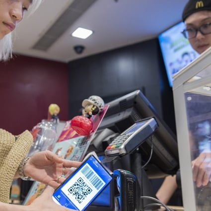 A customer uses her smartphone to pay at a McDonald’s in Shanghai. Pictures: Zigor Aldama
