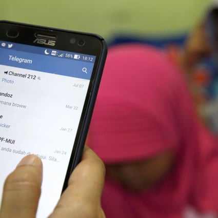 A girl holds a mobile phone as she open Telegram messaging in Jakarta, Indonesia, 16 July 2017. Indonesian government through the Ministry of Communications and Informatics blocked all access to Telegram instant messaging, saying it had many channels that exist in the service that in the value of much charged propaganda radicalism, terrorism, and hate of speech.Photo: EPA