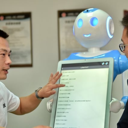 Clients interact with intelligent robots ‘Fa Mengmeng’ and ‘Lyu Mengmeng’ at a law firm in Yuncheng, Shanxi province. Photo: Xinhua