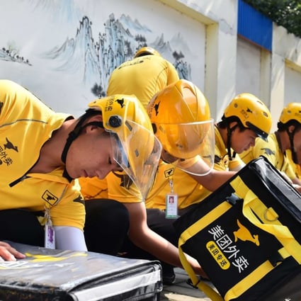 Meituan delivery staff in the eastern city of Jinan prepare their orders. Photo: Xinhua
