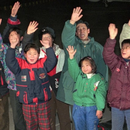North Korean defectors wave after arriving in South Korea by boat in January 1997. Picture AP