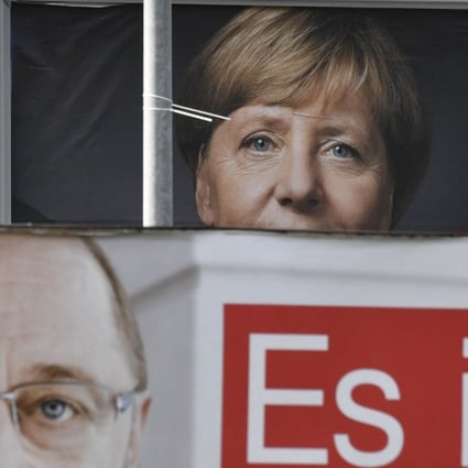 Billboards featuring Angela Merkel and Martin Schulz. Photo: AFP