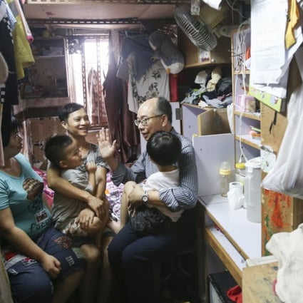 Secretary for Transport and Housing, Frank Chan Fan makes home visits to grassroot people organized by the Society for Community Organization (SoCo) in Sham Shui Po. Photo: David Wong