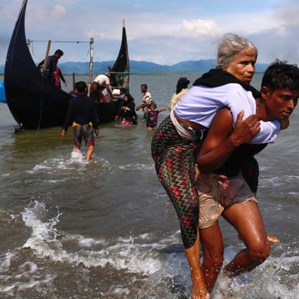 A Rohingya refugee, one of the hundreds of thousands displaced by the conflict in Rakhine, is carried to safety in Bangladesh. Photo: Reuters