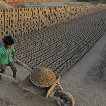 An Indian boy works in a brick kiln on the outskirts of Jalandhar on September 18. Many brick kiln workers in India are trapped in a cycle of bonded labour and regularly cheated out of promised wages, according to anti-slavery groups. Photo: AFP