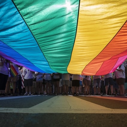 Marchers with a huge rainbow flag at an LGBT protest in Washington in the US in June. Photo: AP