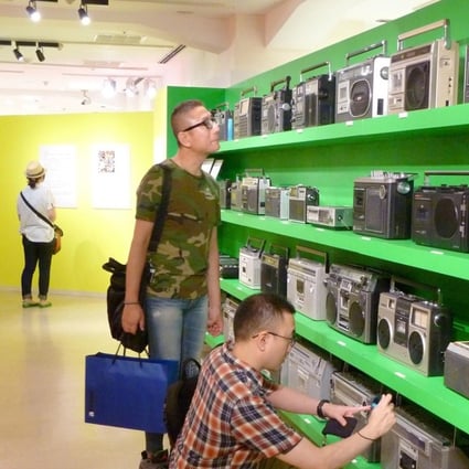 Visitors check out radio-cassette players at an exhibition in the Seibu department store in Tokyo's Shibuya district in August. Along with vinyl's resurgence, the boom box is experiencing a revival. Photo: Kyodo