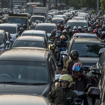 Commuters wait in a traffic jam during afternoon rush hour in Jakarta, Indonesia. Photo; AFP