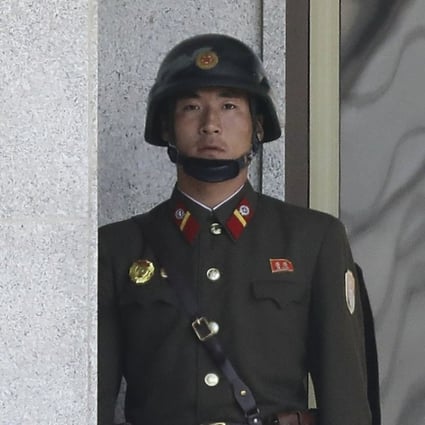 A North Korean soldier looks at South Korea across the Korean Demilitarised Zone as seen from Panmunjom, South Korea. Photo: EPA