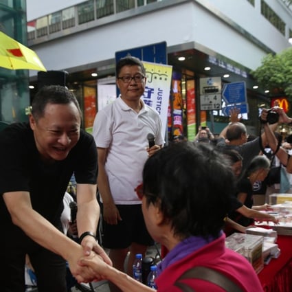 Independence activist Benny Tai Yiu-ting shakes hands with a supporter during a rally in Hong Kong on October 1 with the aim of rejecting “authoritarian rule” and to demand the resignation of Hong Kong’s Secretary for Justice Rimsky Yuen Kwok-keung. Photo: Sam Tsang