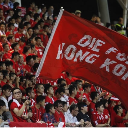 A Hong Kong Fan waves a flag at Mong Kok Stadium, scene of regular booing of the China national anthem.. Photo: AFP
