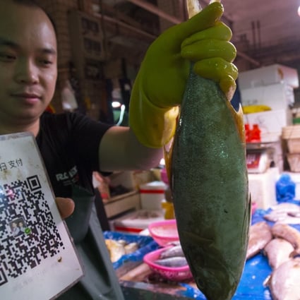 Even fish vendors in China’s wet markets accept mobile payments. Photo: May Tse