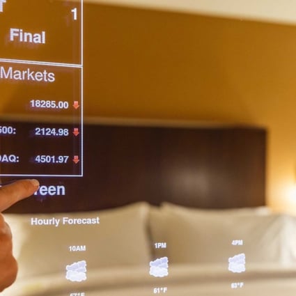 A “smart” mirror in use at a Sheraton hotel. Smart mirrors in the rooms will enable guests to check stock, read news headlines and check the weather on touch screen mirrors. Photo: SCMP Handout