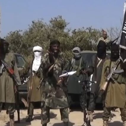 An image grabfrom a 2014 video shows the leader of the Nigerian Islamist extremist group Boko Haram Abubakar Shekau (centre) delivering a speech. Photo: AFP
