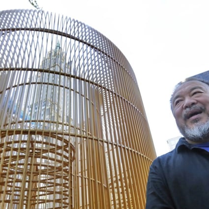 Chinese activist and artist Ai Weiwei poses beside “Gilded Cage”, one of the many works included in his “Good Fences Make Good Neighbours” exhibition in New York. Photo: AP