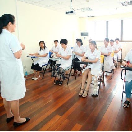 Students take a class on stimulating breast milk secretion in Duole, a Shanghai-based training centre for domestic helpers. Photo: Handout