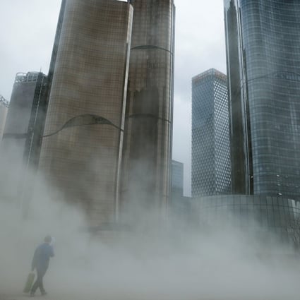A man walks through a cloud of dust whipped up by wind at the construction site near new skyscrapers in Beijing, where a company leasing a 30,000 sq ft grade A office needs to invest US$19,095,807, or US$637 per square foot, over five years. Photo: Reuters