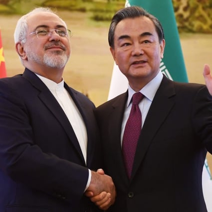 Iranian Foreign Minister Mohammad Javad Zarif (left) shakes hands with Chinese Foreign Minister Wang Yi after a joint media briefing in 2016. China and Iran have close economic, trade and energy ties. Photo: EPA