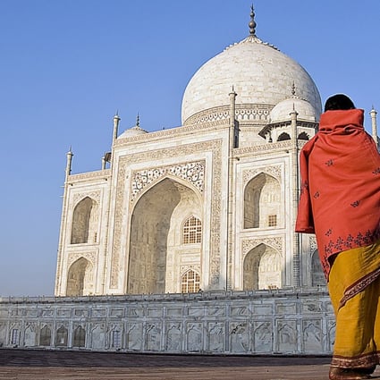 A woman looks up at the facade of the Taj Mahal in Agra, India. Photo: Post Magazine