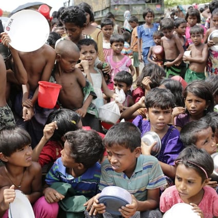 Rohingya children wait outside a food centre to collect lunch at a camp in Bangladesh on October 11. Photo: EPA