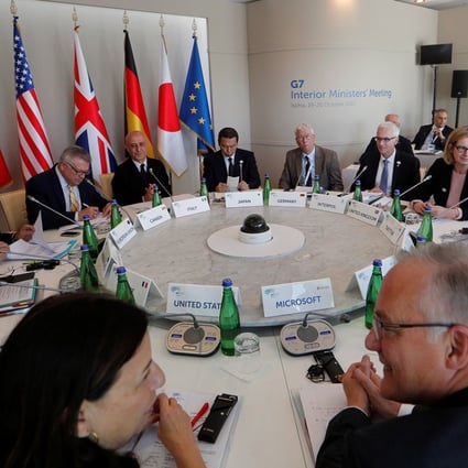 Interior Ministers sit around the table during a G7 Interior Ministers meeting with representatives from the world’s biggest tech firms. Photo: Reuters