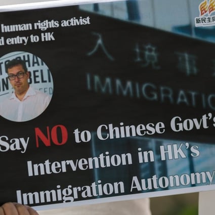 A placard at a protest outside Hong Kong government offices. Benedict Rogers was barred from the city on October 11. Photo: EPA
