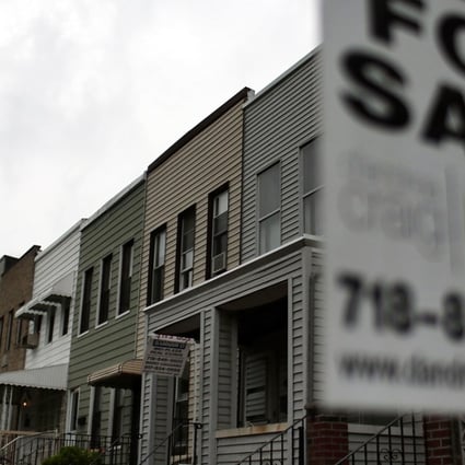 A “For Sale” sign hangs outside a home in New York’s Brooklyn area. According to a triennial study by the Federal Reserve called Survey of Consumer Finances, the average American family's net worth dropped almost 40 per cent between 2007 and 2010, mainly as a result of crashing real estate prices. Photo: AFP