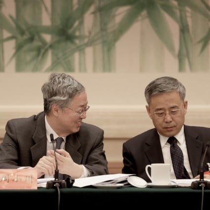 Zhou Xiaochuan, left, governor of the People's Bank of China (PBOC), left, pictured with Guo Shuqing this week at the Communist Party conference in Beijing. Photo: Bloomberg